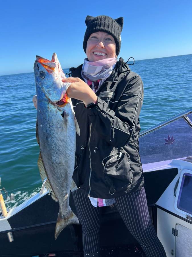 Angler holding a Cape salmon caught off Gansbaai